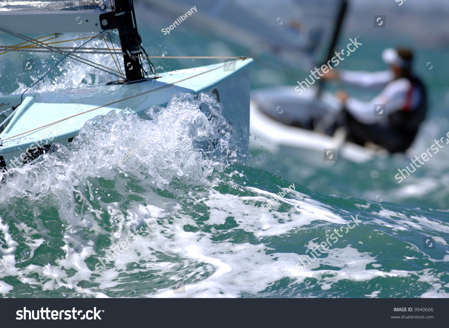 Sailors splash through the waves during a regatta.