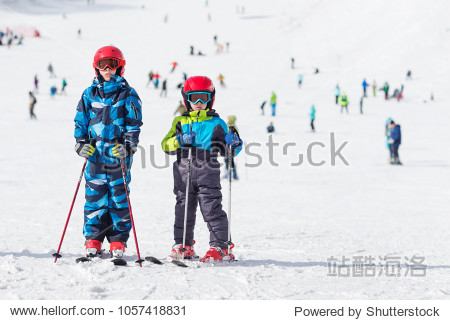 two boys posing on the slope of a ski resort