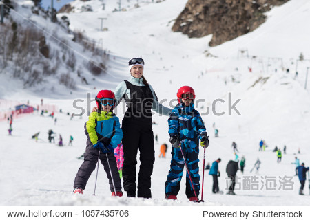 mother with sons on alpine skiing