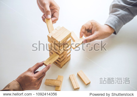 Alternative risk plan and strategy in business Young intelligent business team playing the wood game hands of executive cooperation placing wood block on the tower Collaborative management.