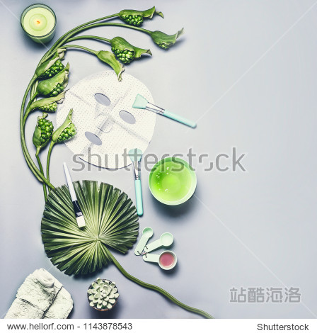 Skin care cosmetic and facial sheet mask. Various serum  cream and gel cosmetics product with tropical leaves and flowers on gray background  top view with copy space. Beauty concept