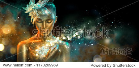 High Fashion model woman in colorful bright golden sparkles and neon lights posing with fantasy flower portrait of beautiful girl glowing make-up. Art design colorful make up. Glitter Vivid neon skin