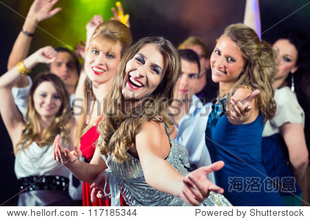 young people dancing in club or disco and have party; the girls