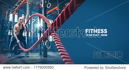 Woman with battle rope battle ropes exercise in the fitness gym. gym sport rope training athlete workout exercises concept