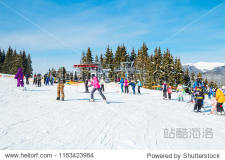 several skiers on a snowy road.Winter holidays in the mountains. Mountain-skiing resort in the Carpathians