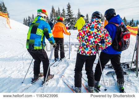 several skiers on a snowy road.Winter holidays in the mountains. Mountain-skiing resort in the Carpathians several skiers on a snowy road.Winter holidays in the mountains. Mountain-skiing resort in the Carpathians