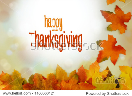Autumn leaves form a bborder against a bokeh background with sunflare and seasonal colors. Seasonal text message added.