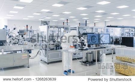 Shot of Sterile Pharmaceutical Manufacturing Laboratory where Scientists in Protective Coverall's Do Research Quality Control and Work on the Discovery of new Medicine.