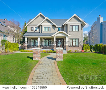 luxury house with long doorway and nicely trimmed front yard in