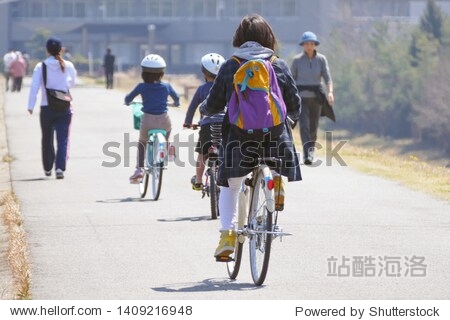 Japanese riding a bicycle with three parents