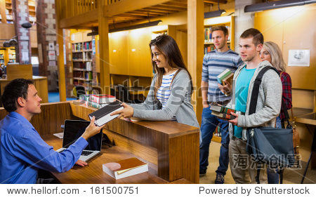 young students in a row at the counter in college library