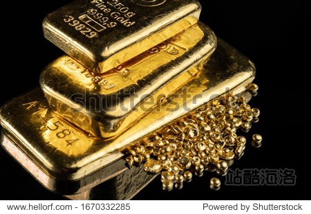 Several gold bars of different weight and a pile of pure gold granules on a mirror dark background.