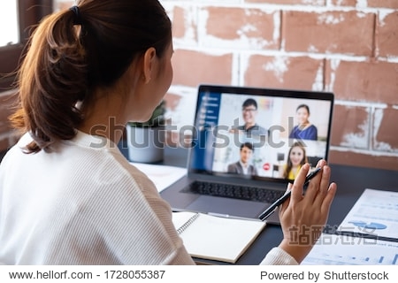 Young Asian businesswoman work at home and virtual video conference meeting with colleagues business people online working video call due to social distancing at home office