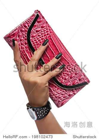 holding a red crocodile skin texture clutch on white studio back
