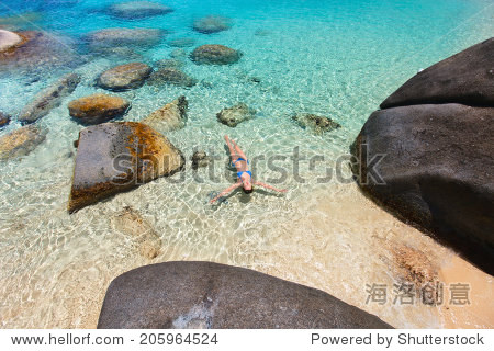 above view of beautiful young woman relaxing floating in