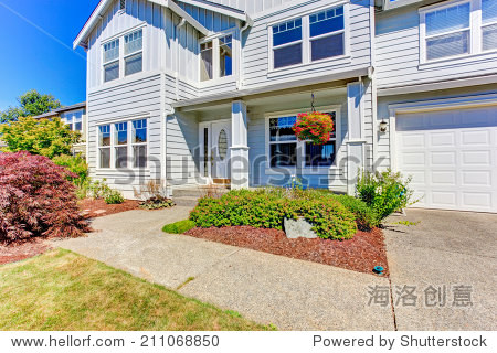 large american house with classic entrance porch, garage and