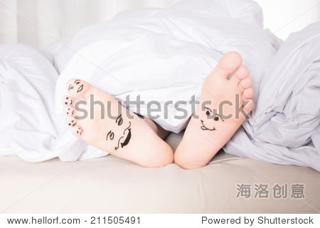 bare feet with smiley faces drawn on bottom