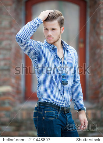 handsome young man wearing a blue shirt and jeans