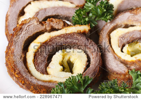 meat roll with scrambled eggs and cucumber macro on a white