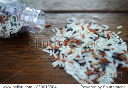 close-up multicolor rice from bottle sprinkle on the wooden