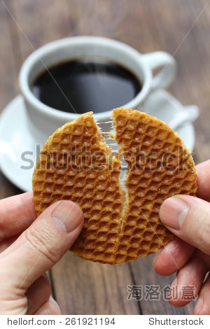 stroopwafel split by hands dutch snack and coffee