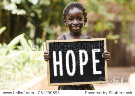 a girl holding a chalkboard with "hope" written on it.