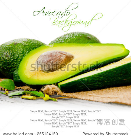 photo of avocados with slice and leaves on burlap and wooden