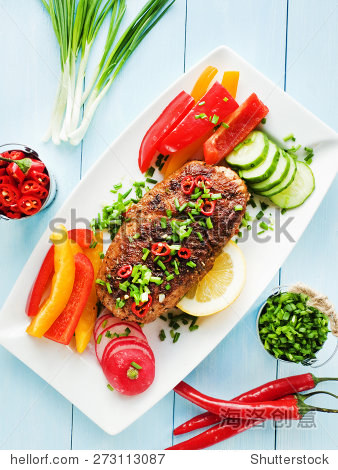 argentinian asado pork fillet with herbs, veggies and sauce.