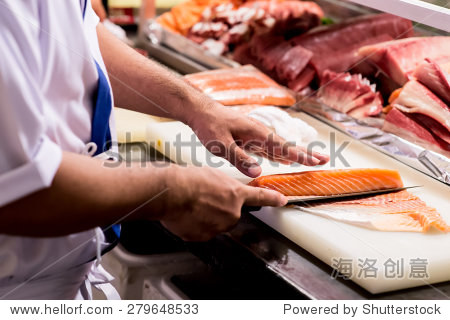 with a knife,japanese chef making sashimi in kitchen,sushi are