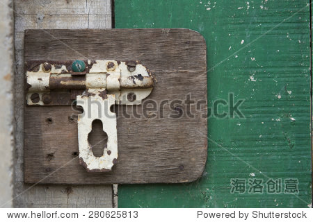 closeup of old vintage door latch on green door
