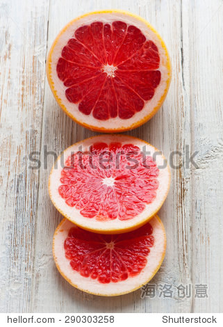 grapefruit with slices on a wooden table.