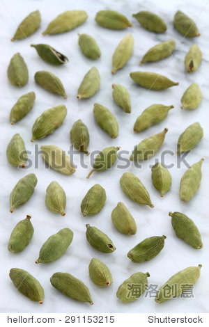 beautiful cardamom pods, on top of carrara marble coutertop.