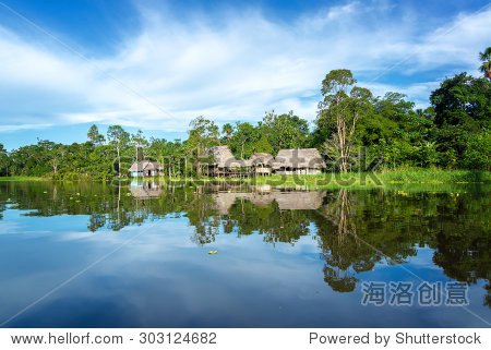 Small town in the Amazon rain forest reflected i