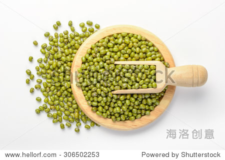 raw mung bean in the wooden plate, isolated on white, top view
