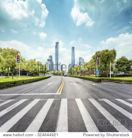 empty road with zebra crossing and skyscrapers in modern city