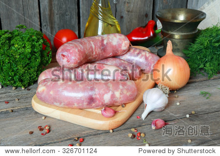 raw meat sausages on a cutting board on the ki