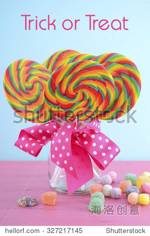 lollipops in glass jar with pink polka dot bow candy on pink and