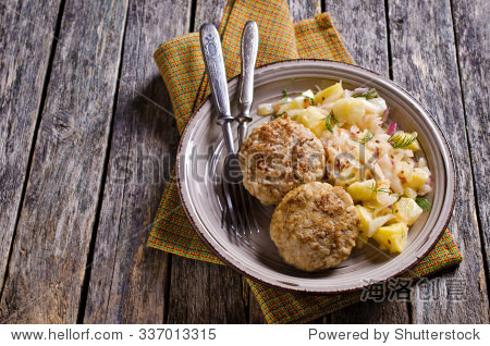 cutlets from minced meat and rice on a plate with vegetable