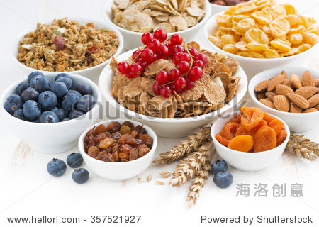 assortment of different breakfast cereal, dried fruit and fresh