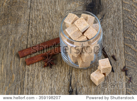 brown sugar with cinnamon and clove seeds on the wood