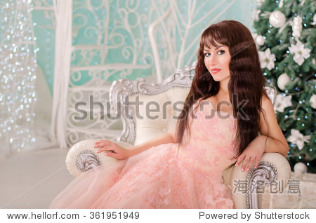 the girl in a beautiful wedding dress, sitting in a luxury chair