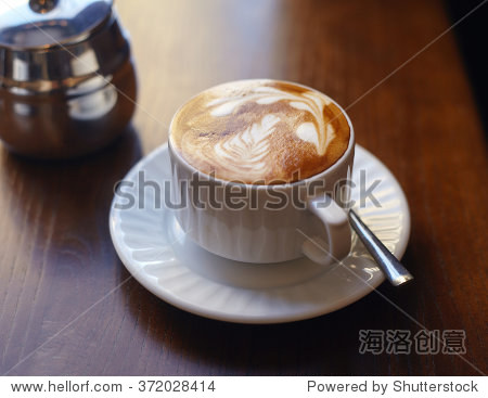 close up picture of a cup of coffee with a picture on it.