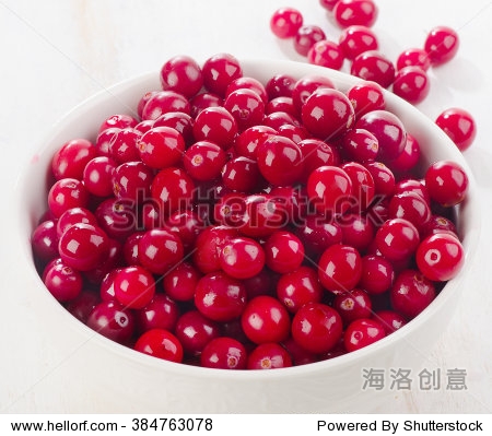 fresh cranberries in white bowl.