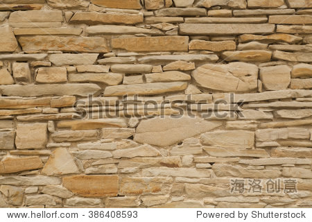 wall made from sandstone bricks of irregular shapes slotting