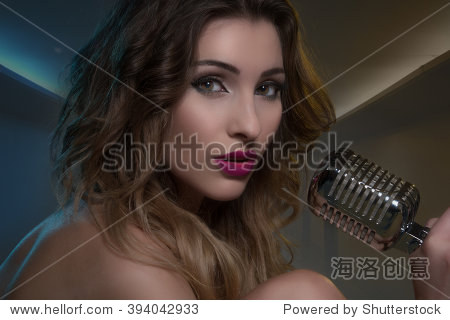 beautiful brunette with retro microphone naked with big curly