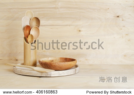 Home Kitchen Decor: wooden cutlery spoons in a bamboo container on a wooden board background. Cozy arrangement rustic style.