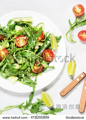 green vegetarian salad with rocket on the white wooden back