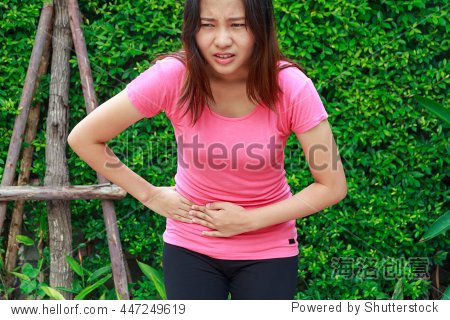 woman touching her own belly with stomachache, appendicitis pain