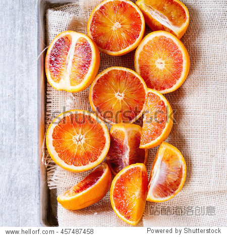 sliced sicilian blood oranges fruits in aluminum tray with white