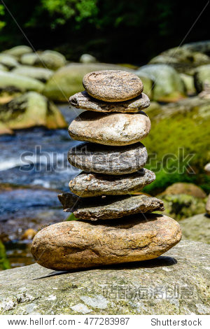 stones piled in mounds on the river bank